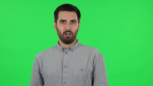 Portrait of Brunette Guy Is Saying Oh My God and Being Shocked. Green Screen alt