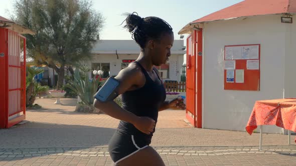Attractive young black athlete running. Training, competition-slow motion alt