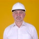 Portrait of Senior man builder in helmet posing on yellow background. - VideoHive Item for Sale