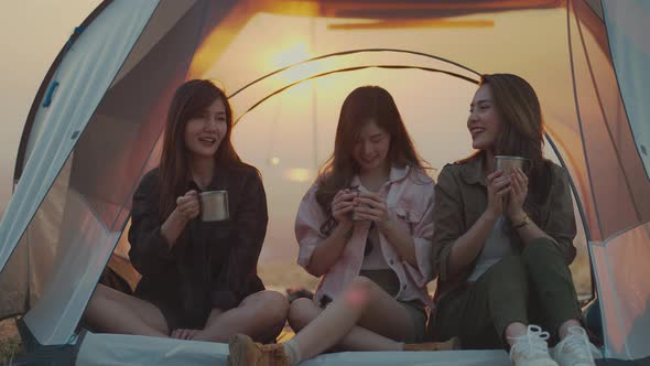 Asian young women drinking coffee in a tent.