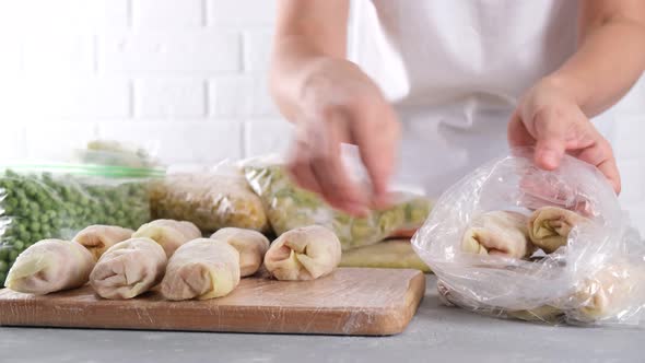 Frozen food. Woman packing frozen stuffed cabbage roll