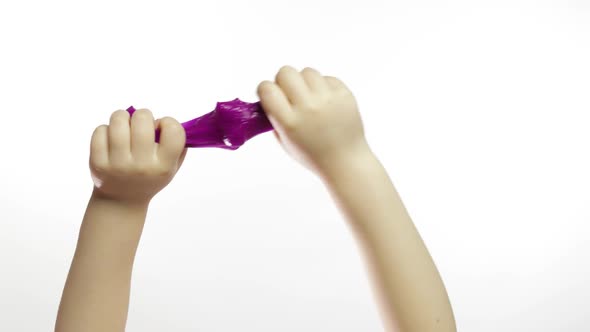 Child Hands Playing Oddly Purple Slime on White Background. Antistress alt