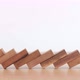 Domino effect made up from wooden blocks shape toy on wooden desk - VideoHive Item for Sale