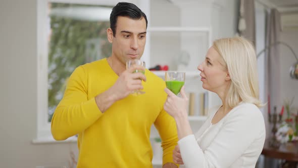 Portrait of Handsome Middle Eastern Man and Beautiful Caucasian Woman Drinking Healthful Vegetarian alt