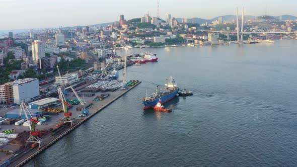 Mooring By Tugs of a Cargo Ship with a Cargo of Vehicles alt