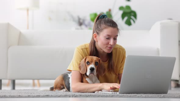 Spending Time with Lovely Pet Woman with Beagle at Laptop Spbi alt