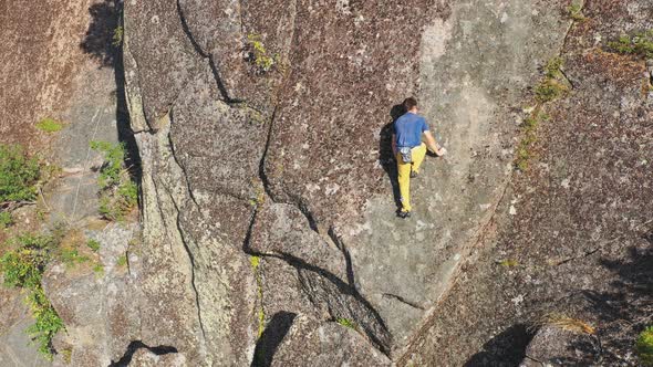 Free Solo Climbing on a Steep Rock Wall