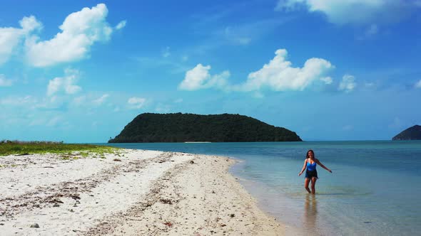 Beautiful teenage girl refreshing in the crystal clear tropical waters. Summer holiday relief concep alt