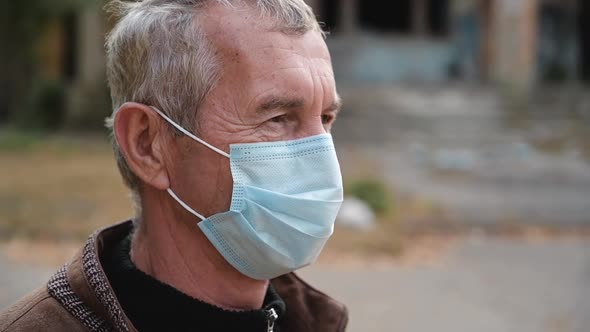 Close Up Portrait of Senior Man Wearing Protective Medical Face Mask