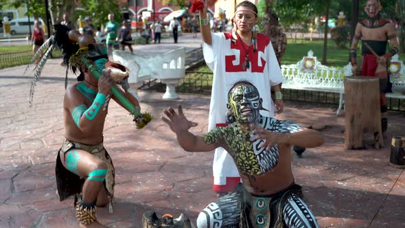 Mayan dancers performing to live drums outside in a park in Valladolid, Mexico. alt