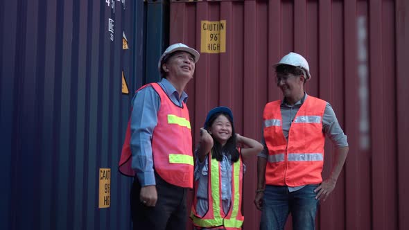 Cheerful father daughter and senior engineers in a shipyard