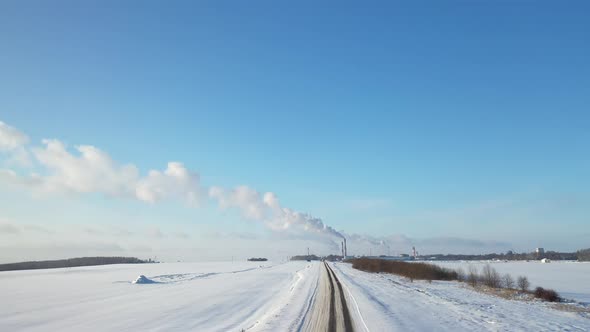 Smoke from the pipes of a chemical enterprise top view. Panorama of the factory in winter.