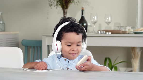 Little African Kid Listening to Music on Smartphone