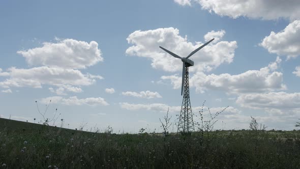 Windmill on the fields with clouds in background