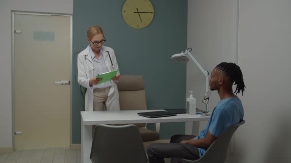 Young Adult Patient Greeting Female Physician in Doctor's Office alt