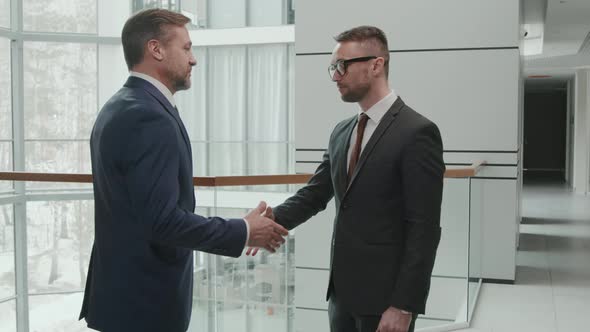 Business Man and Lawyer Shaking Hands in Office alt