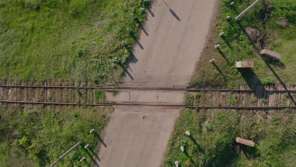 the Railroad Crossing at Rural Landscape. Top Down Aerial View. 