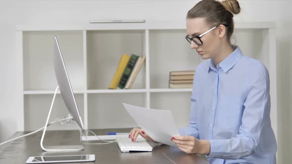 Paperwork By Young Casual Girl Working On Computer alt