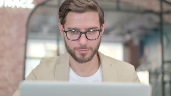 Thumbs Up By Young Man with Laptop alt