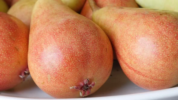 European common pear tasty fruit pile slow tilt 4K 2160p 30fps UltraHD footage - Close-up tilting on alt