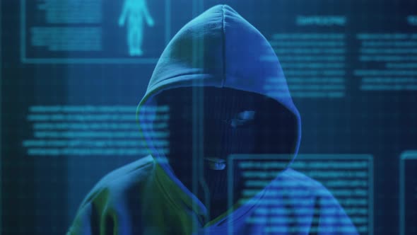Cybercriminal Hacker in a Mask Closeup Rejoices
