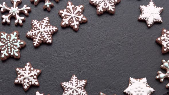 Top View of Handlaid Gingerbread Cookies Snowflakes on Slate Table