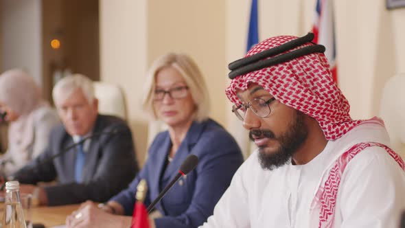 Arab Politician Speaking in Microphone at Press Conference alt
