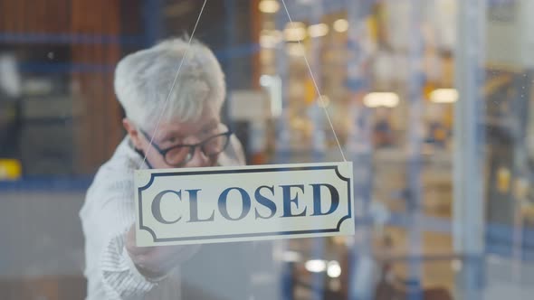 Senior Coffee Shop Owner Setting Open Sign at Glass Door for Welcome Customers alt