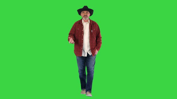 Ranch Owner in a Cowboy Hat Walking and Telling a Story on a Green Screen Chroma Key alt