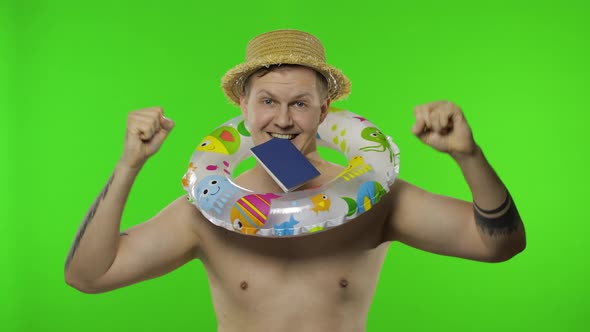 Shirtless Tourist with Swimming Ring and Passport in Mouth. Celebrates, Dances alt