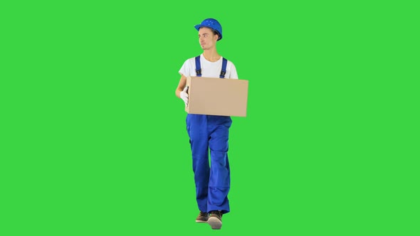 Man Worker Holding a Box and Walking on a Green Screen Chroma Key alt