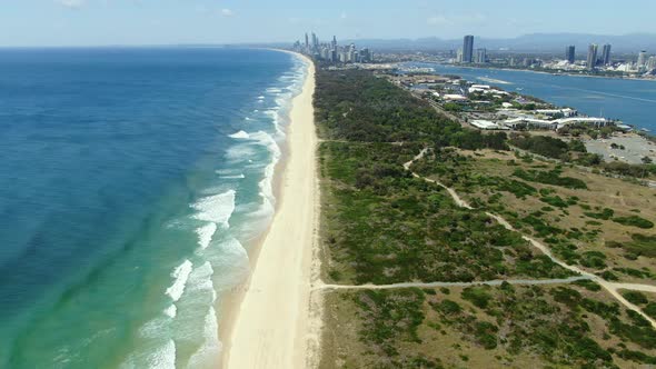 Distant view of waves slowly rolling to the perfect beaches of Surfers Paradise, Gold Coast, Queensl alt