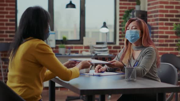 Candidate Giving CV Resume to HR Recruiter in Startup Office alt