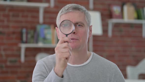 Senior Old Man Searching By Magnifying Glass alt