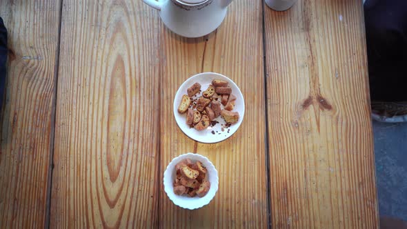 Hands of Two People Taking Snacks Kept in a Bowl in Manali , Himachal Pradesh , India During Tea alt