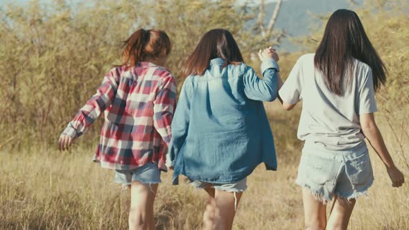 Three young Asian women running having fun together a summer traveling.