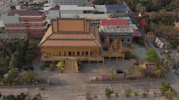 Top view of Golden Temple of Phnom Penh in Cambodia - Aerial Orbit point of interest shot alt