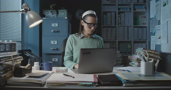 Professional secretary sitting at desk and working