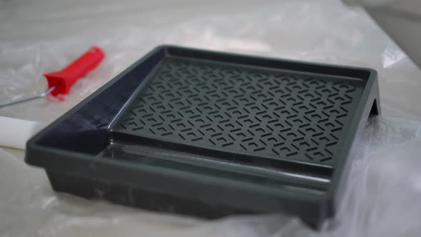 Closeup Painting Tray with White Paint Pouring Inside alt