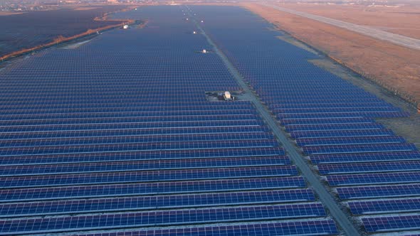 Close Up Drone View of Solar Panels Stand in a Row in the Fields Power Ecology Innovation Nature alt