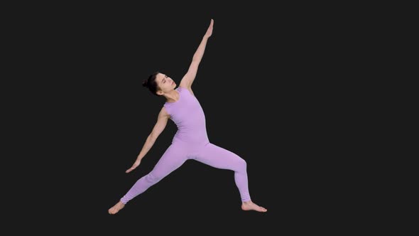 Young Woman Doing Extended Side Angle Pose for Beginners while Practicing Yoga, Alpha in