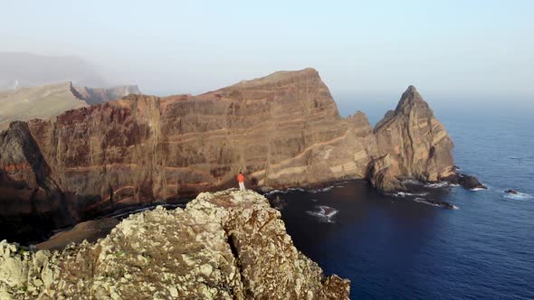 Man Standing on Top of a Cliff at Ponta de Sao Lourenco, Madeira Island, Portugal