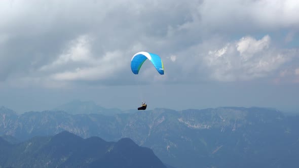 Paraglider and Clouds over the Mountains