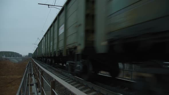 Freight Train Close To the Camera on the Railway Bridge on the Right alt