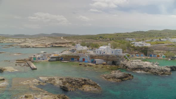 Aerial Pan of the Fishing Village of Mandrakia in the Island of Milos Greece alt
