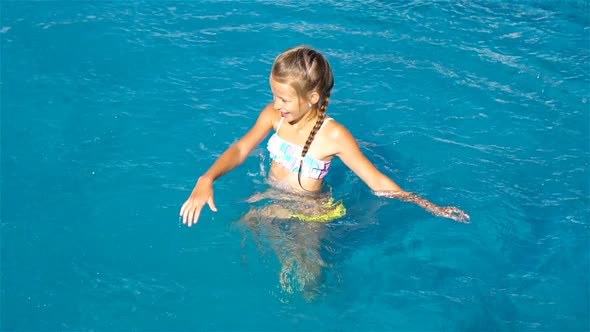 Adorable Little Girl in Outdoor Swimming Pool