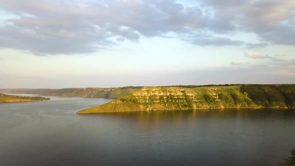 Aerial view of wide Dnister river and distant rocky hills in Bakota area, part of the National park  alt