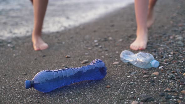 Barefoot Volunteers Collecting Bottles Near Sea