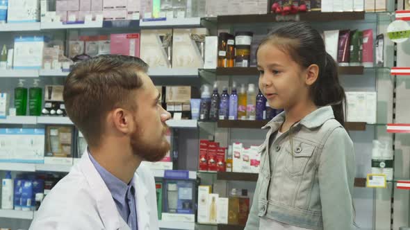 A Friendly Druggist Shakes Hands with a Little Girl alt