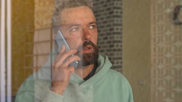 Happy Bearded Man Calling with Mobile Phone